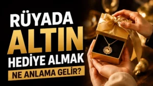 Rüyada altın hediye almak ne anlama gelir başlıklı, altın renkli hediye kutusu içinde kolye bulunan ve sıcak ışık tonlarıyla hazırlanmış kapak görseli.